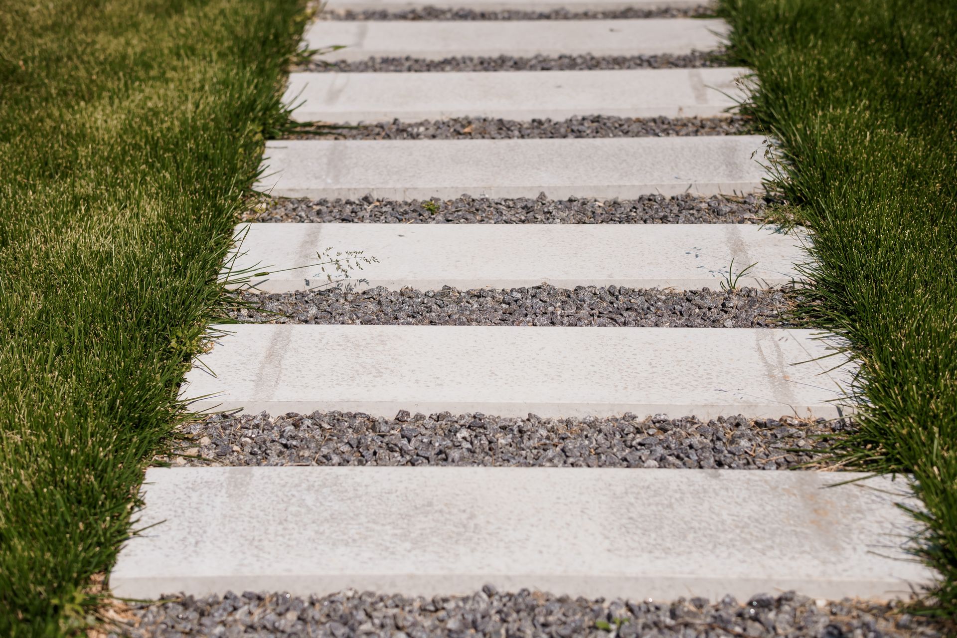 Stone pathway with grass and gravel.
