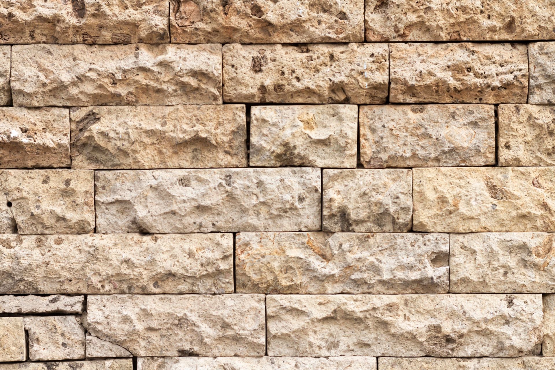 A close up of a brick wall with a lot of bricks.