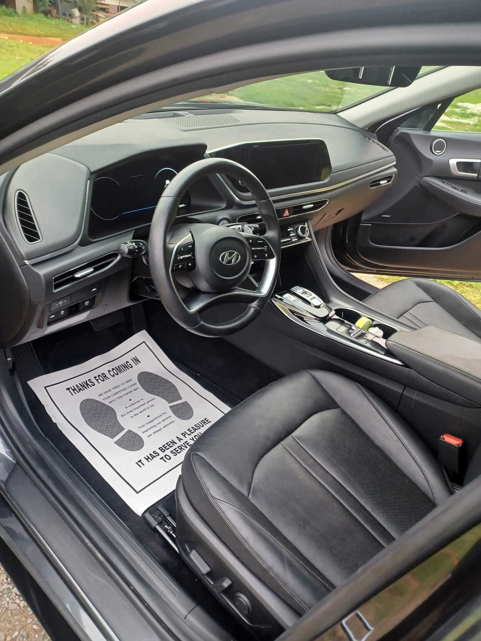 the inside of a black car with a steering wheel and seats .