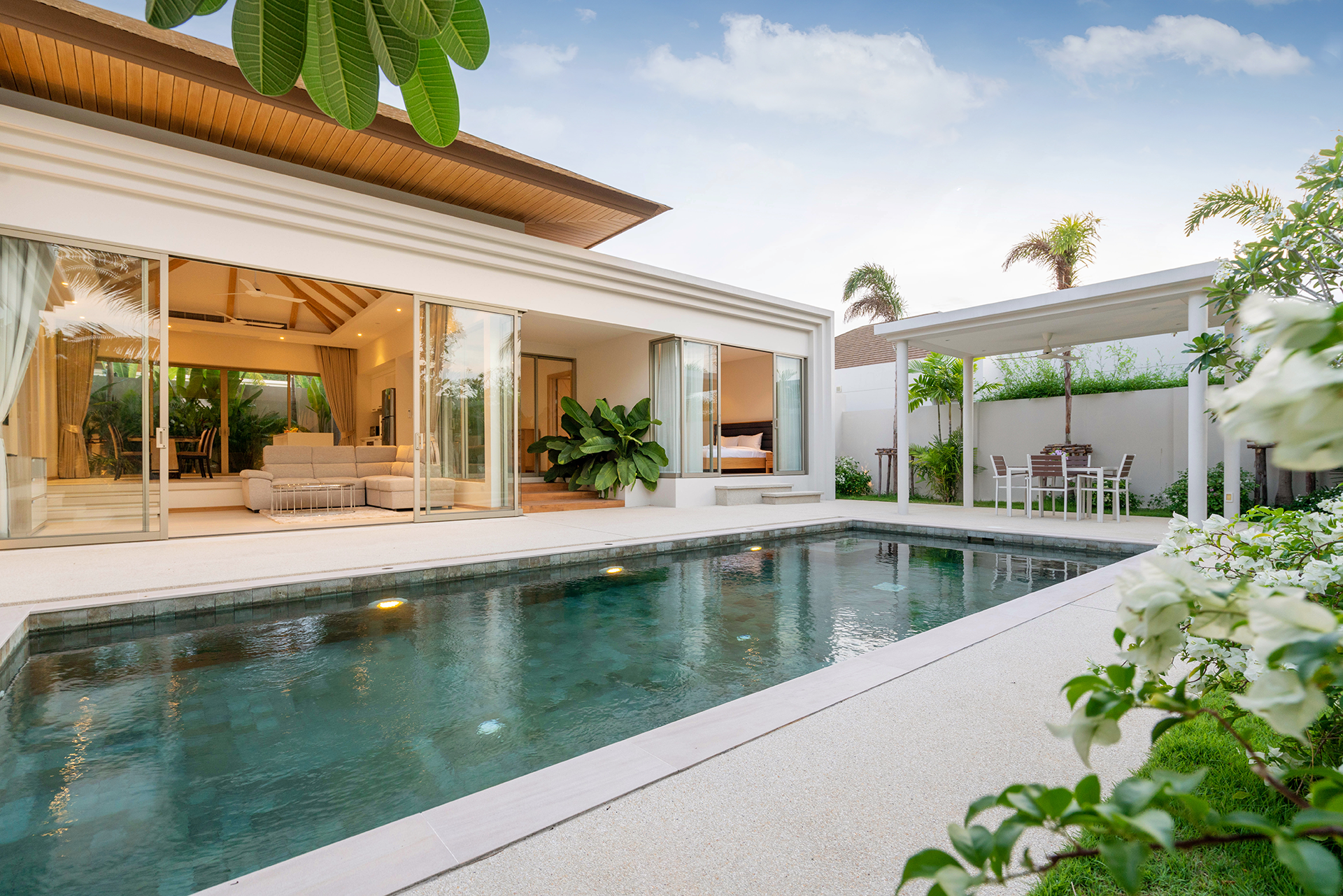 A large house with a swimming pool in front of it.