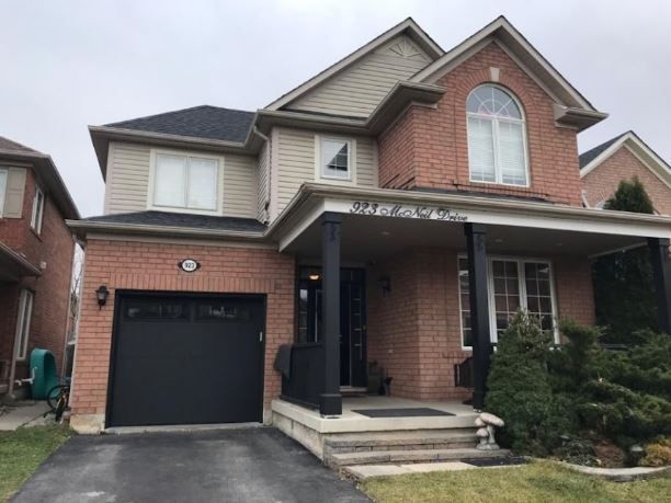 A large brick house with a black garage door