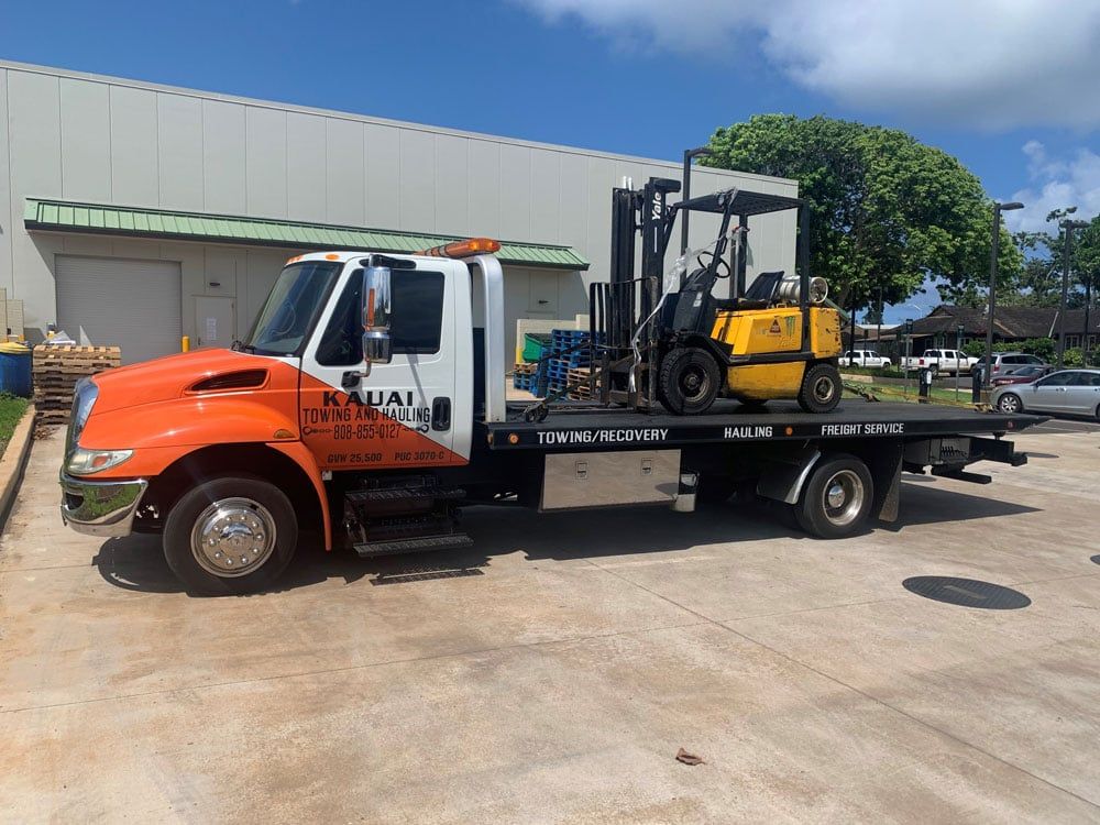 Kauai Towing and Hauling truck with construction equipment