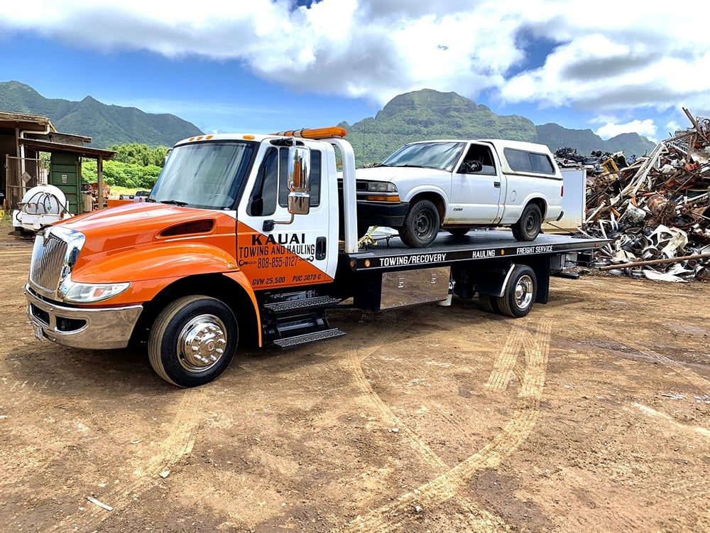 Kauai Towing and Hauling truck hauling a vehicle