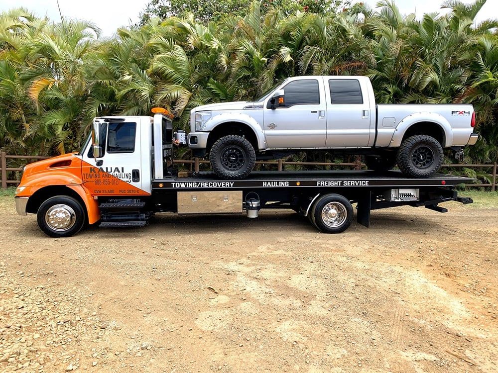 Kauai Towing and Hauling truck hauling a vehicle