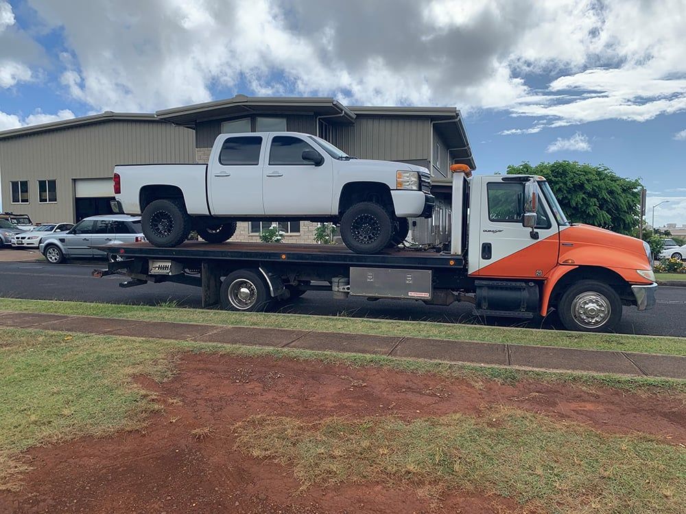 Kauai Towing and Hauling truck hauling a vehicle