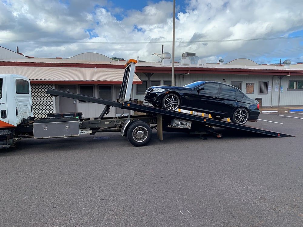 loading a car onto a flatbed for towing