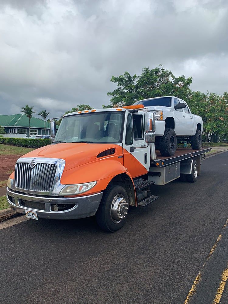 Kauai Towing and Hauling truck hauling a vehicle