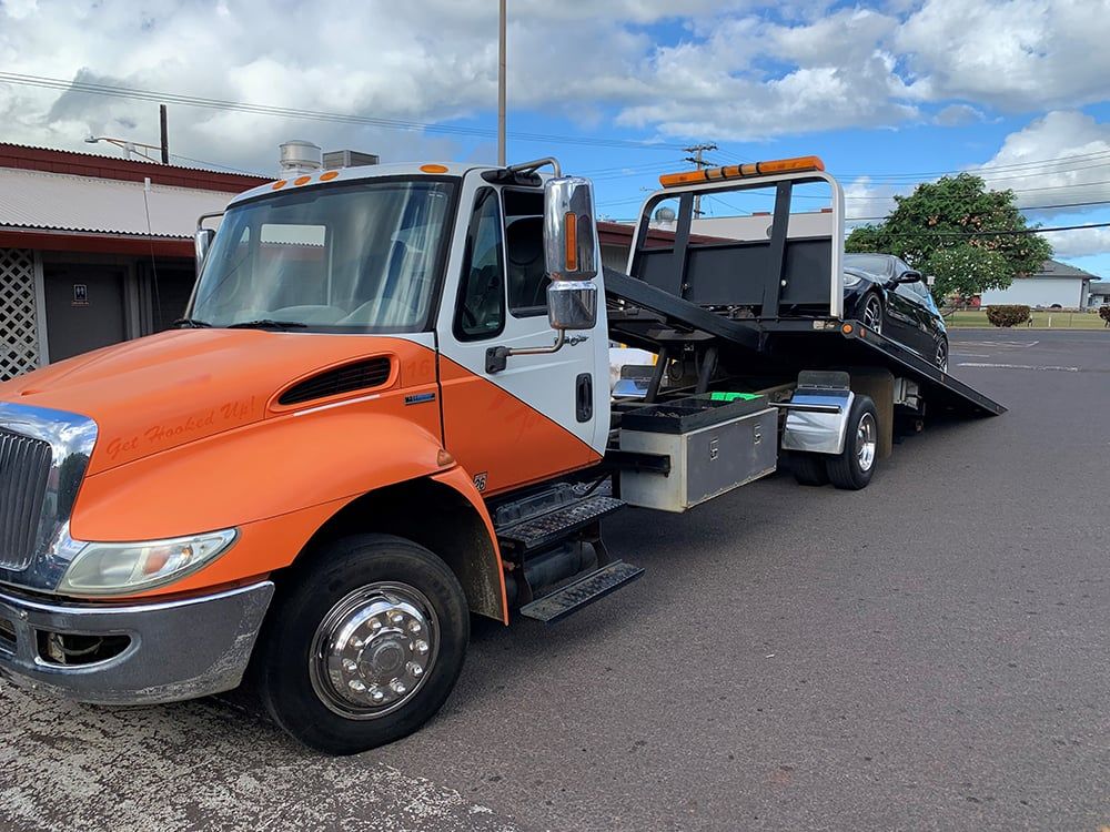 Kauai Towing and Hauling truck hauling a vehicle
