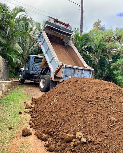 dump truck bringing a load of a dirt