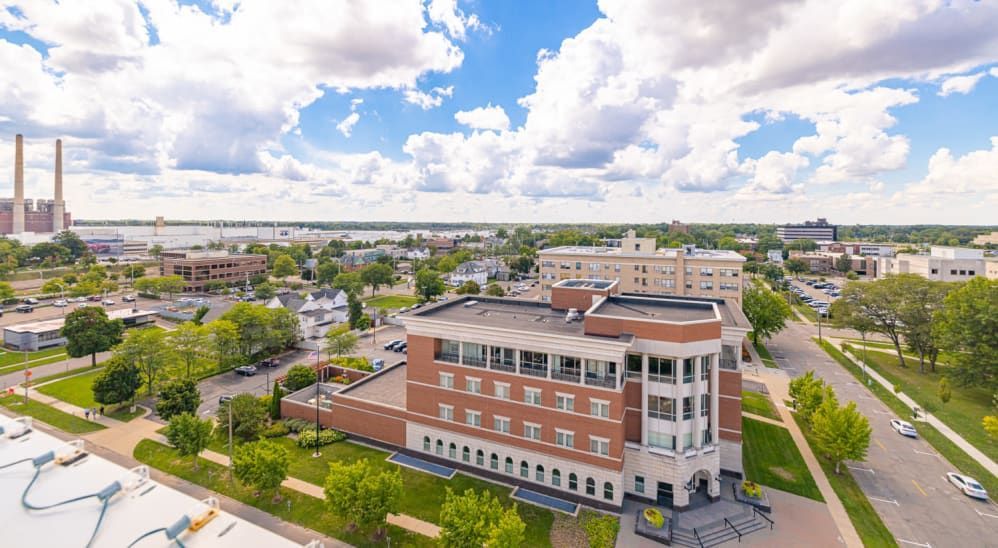 An aerial view of a large building in the middle of a city.