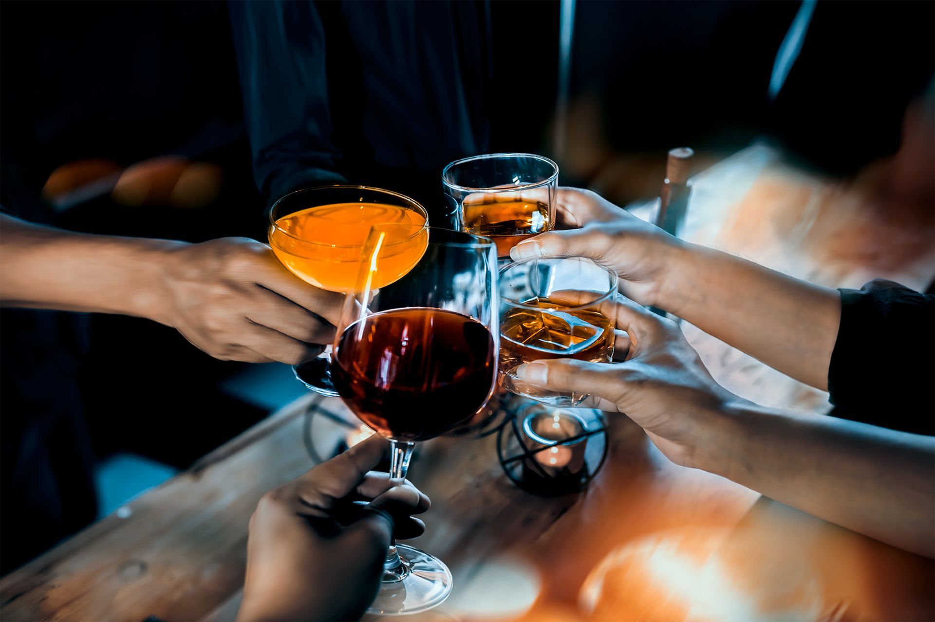 A group of people are toasting with wine glasses.