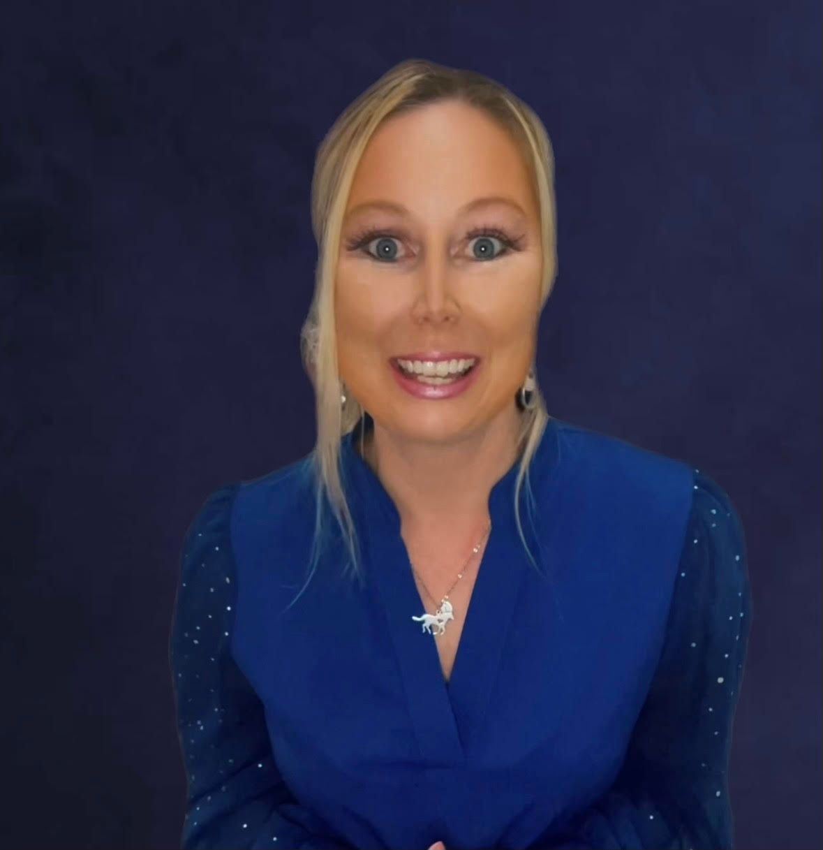 Man in a dark suit and tie, smiling slightly, against a muted, warm background.
