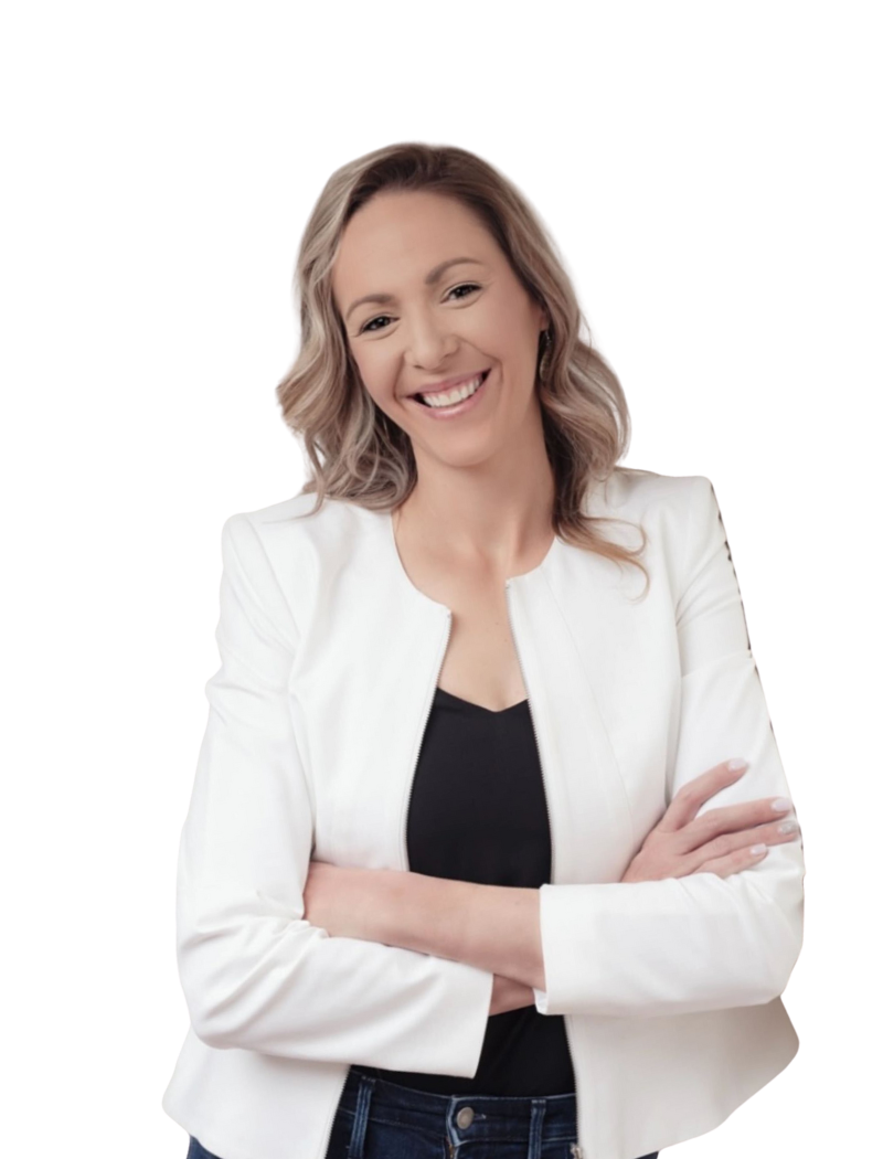 Man in a dark suit and tie, smiling slightly, against a muted, warm background.