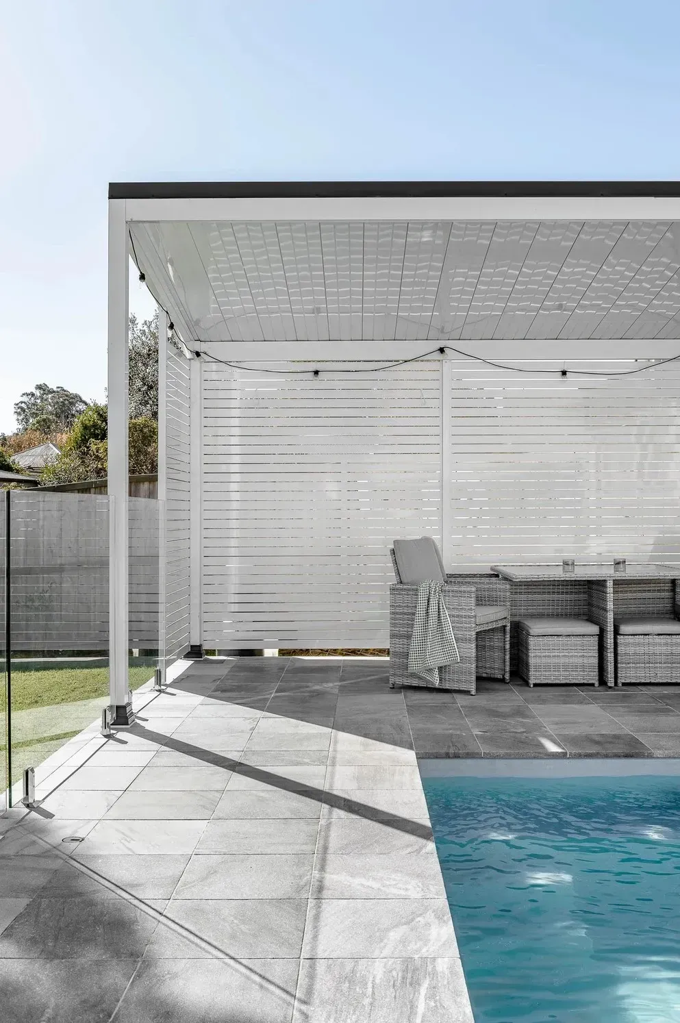 A Pergola Is Sitting Next to A Swimming Pool — Billabong Pool Co in Smeaton Grange, NSW