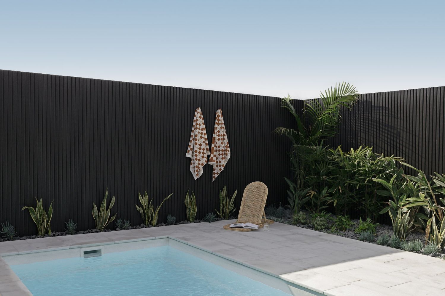  a Swimming Pool in The Backyard with A Black Fence — Billabong Pool Co in Smeaton Grange, NSW