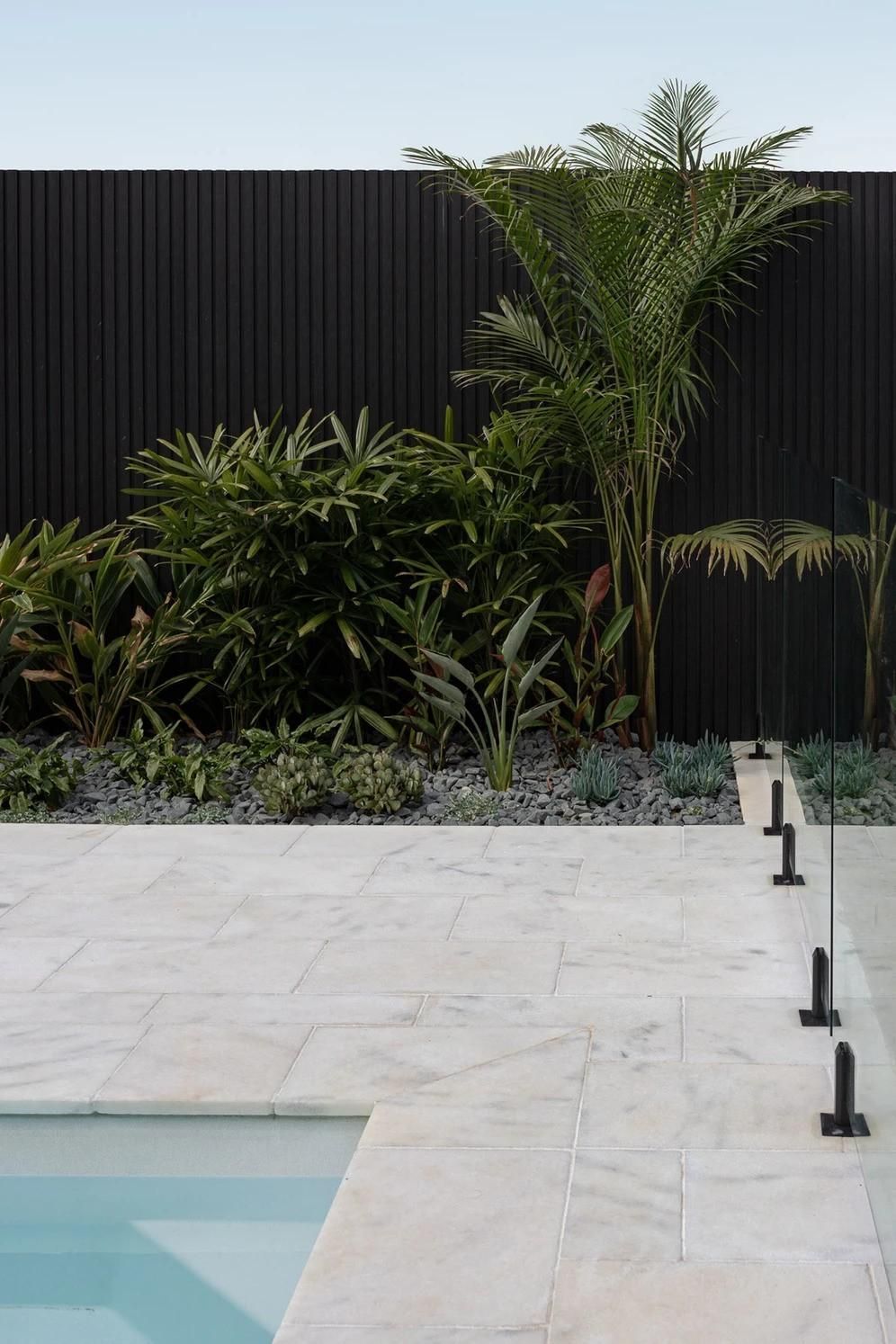 A Swimming Pool in The Backyard with A Fence — Billabong Pool Co in Smeaton Grange, NSW