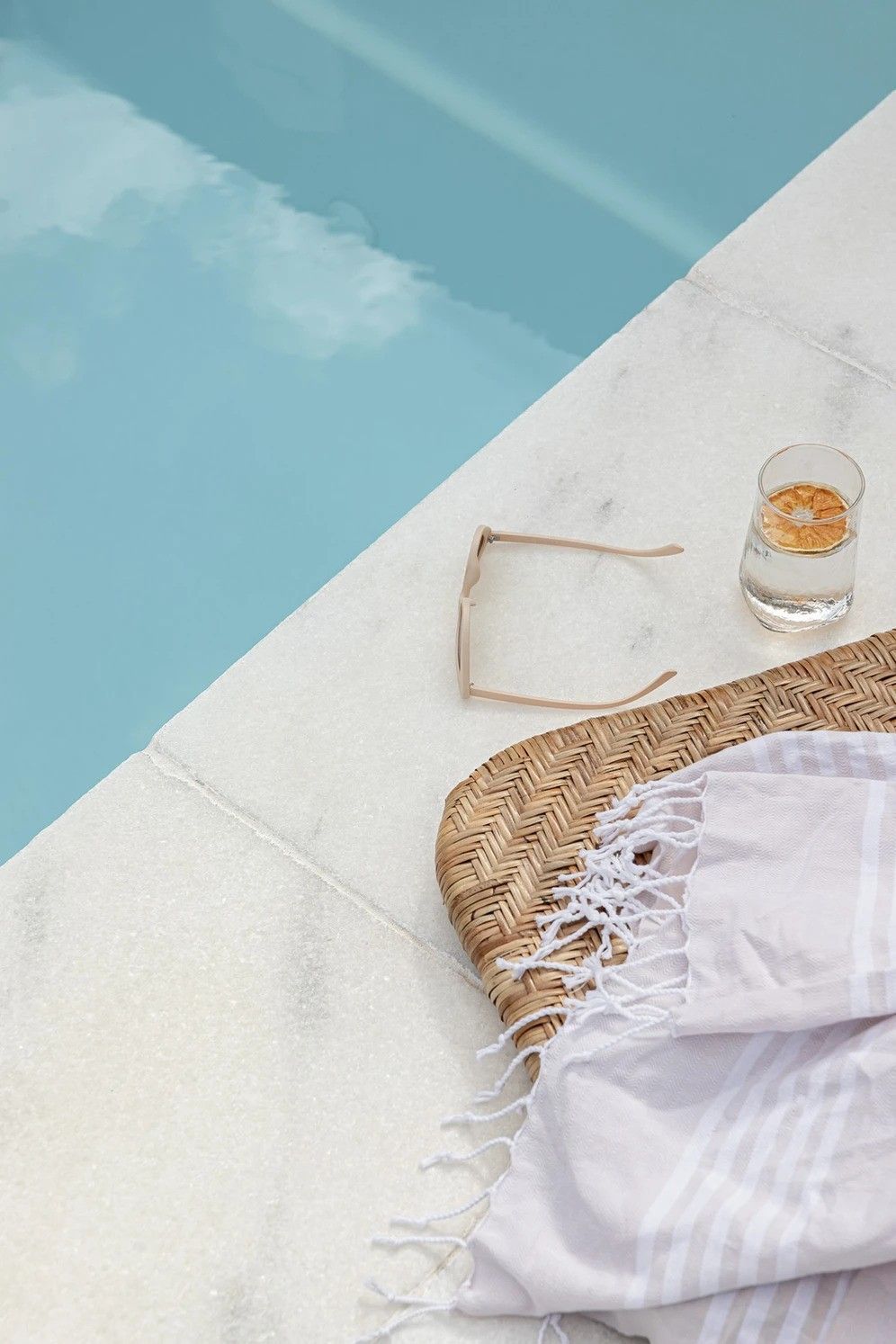 A Glass of Water Are on The Edge of A Swimming Pool — Billabong Pool Co in Smeaton Grange, NSW