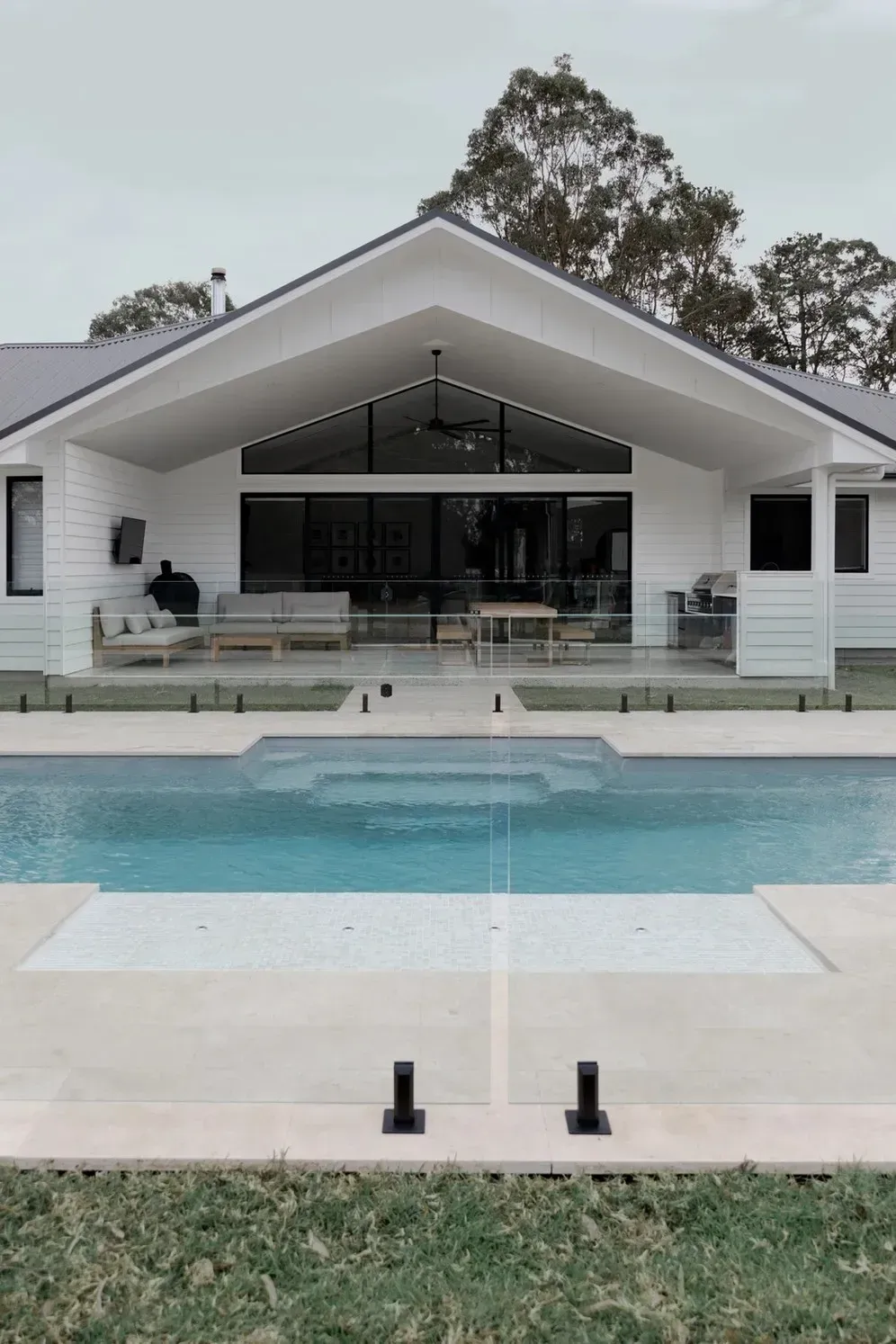 A House with A Large Swimming Pool in Front of It — Billabong Pool Co in Smeaton Grange, NSW