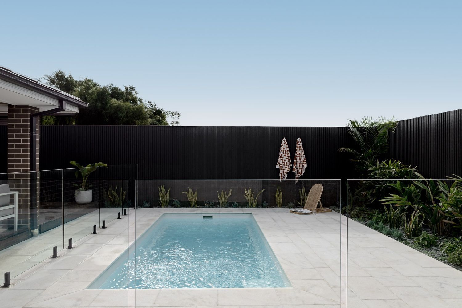 A Large Swimming Pool in The Backyard of A House — Billabong Pool Co in Smeaton Grange, NSW