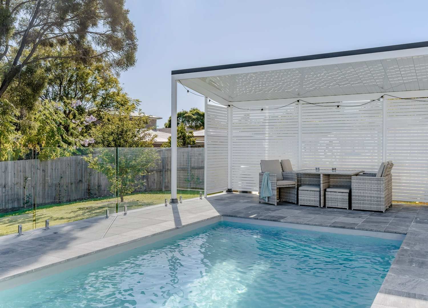 A Swimming Pool with A Pergola and A Table and Chairs — Billabong Pool Co in Smeaton Grange, NSW
