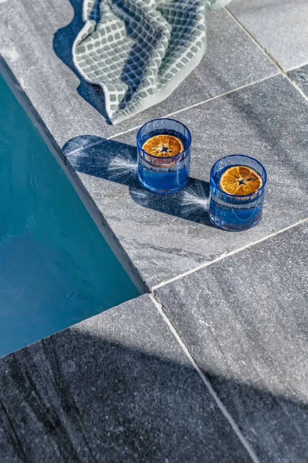 Two Glasses Are Sitting Next to A Pool — Billabong Pool Co in Smeaton Grange, NSW