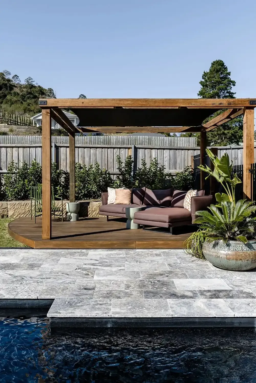 A Wooden Pergola Is Sitting Next to A Swimming Pool — Billabong Pool Co in Smeaton Grange, NSW