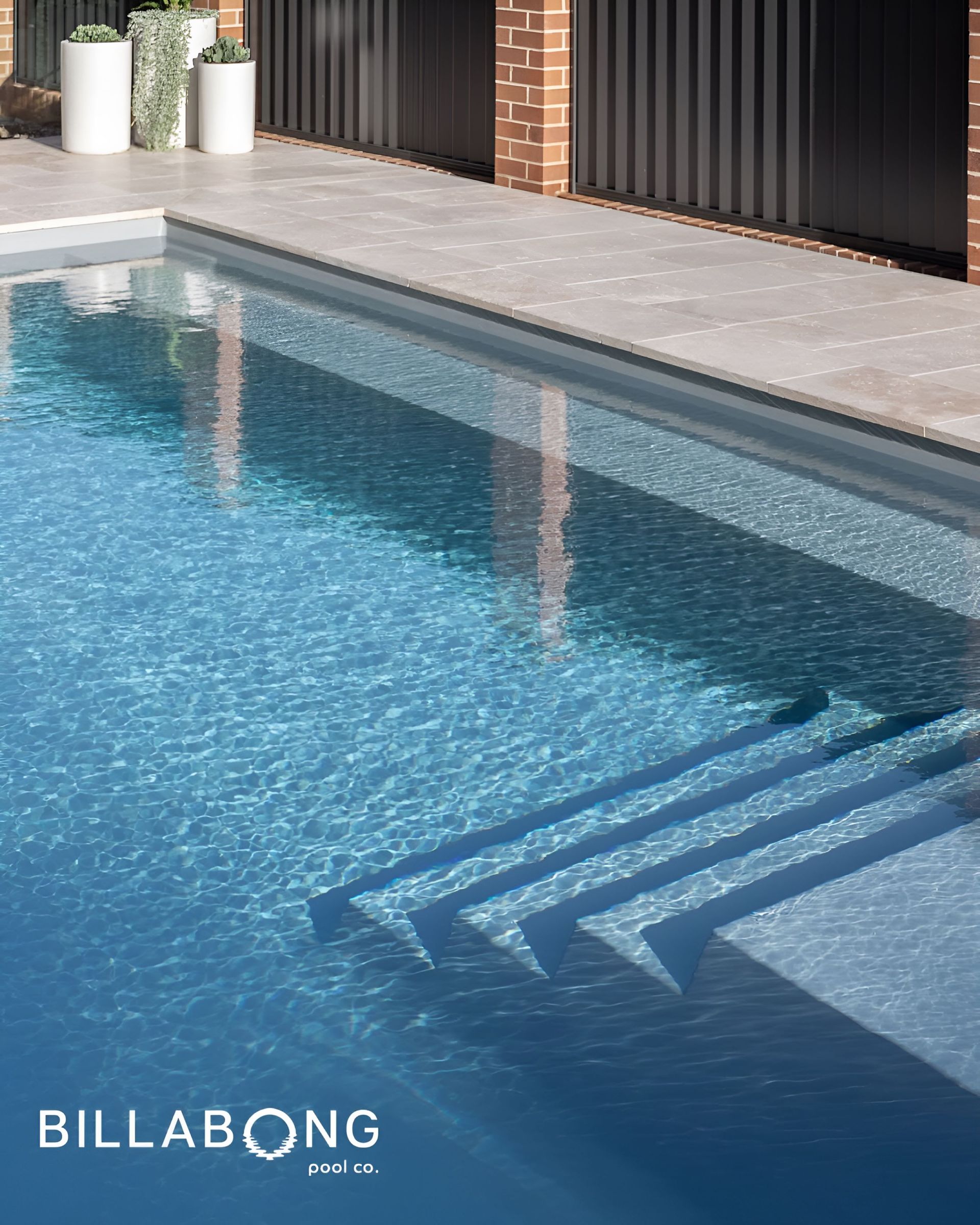 Pool with blue rippling water — Billabong Pool Co in Smeaton Grange, NSW
