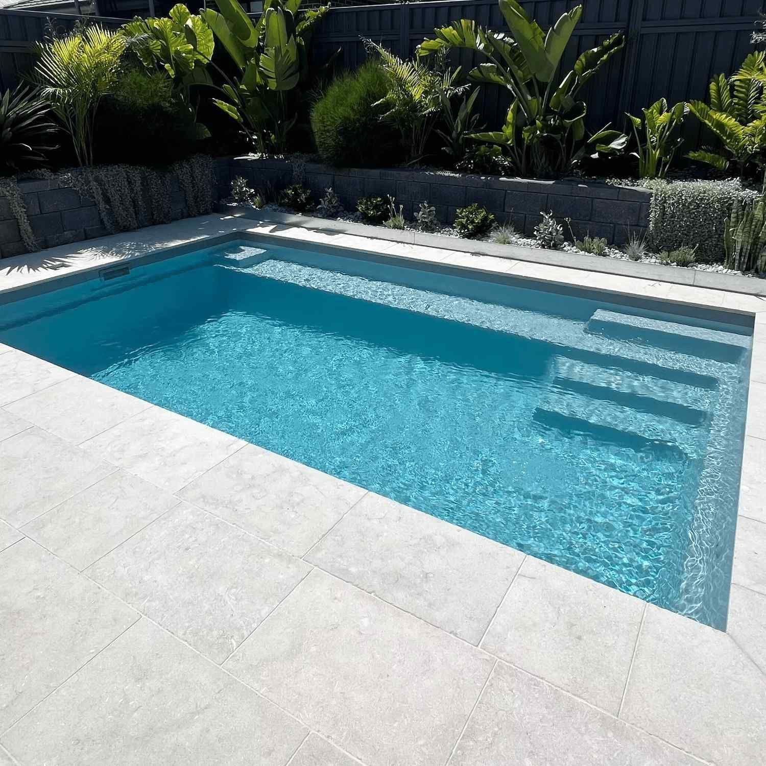 A Swimming Pool with Stairs and A Fence — Billabong Pool Co in Smeaton Grange, NSW