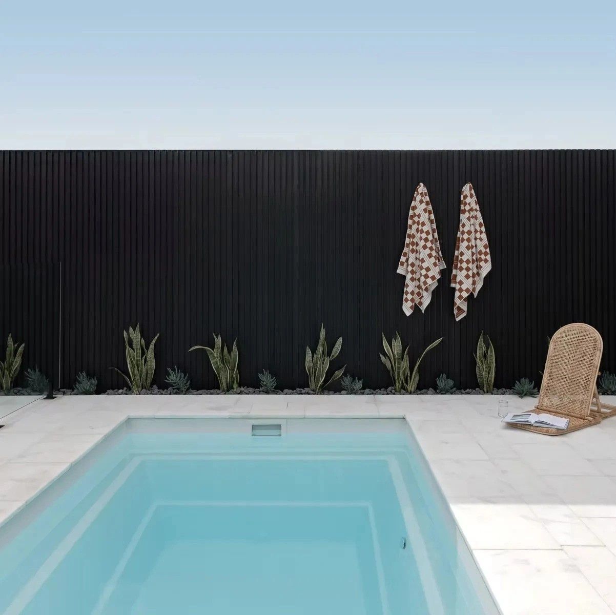 A Swimming Pool with A Black Fence Behind It — Billabong Pool Co in Smeaton Grange, NSW
