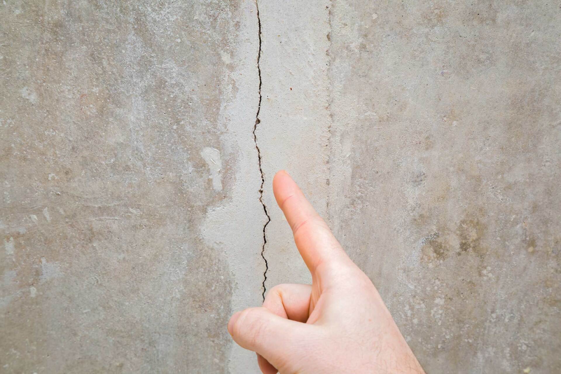Man Hand Finger Pointing To Cracked Ceiling - Warren, MI - Maple Lane Pest Control
