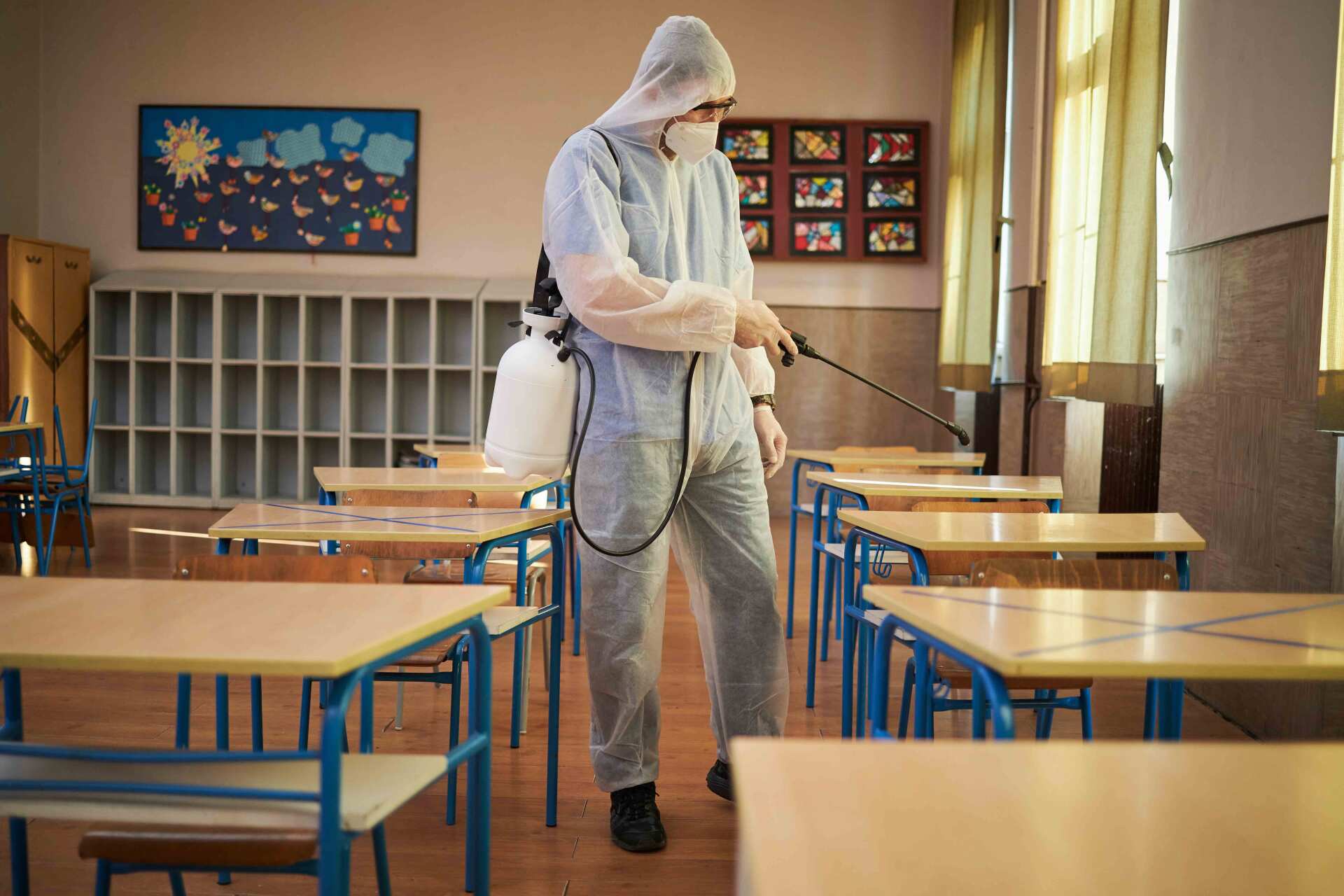 Medical Worker In A Protective Gear Disinfecting A School Classroom - Warren, MI - Maple Lane Pest Control