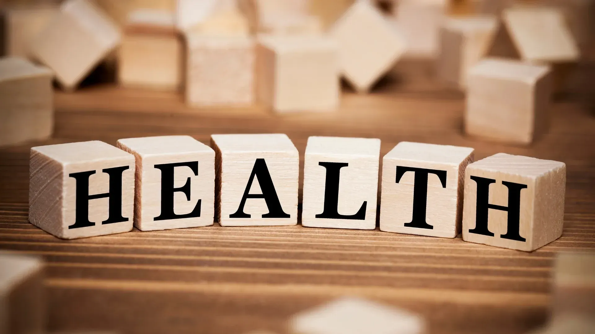 the word health is written on wooden blocks on a wooden table .