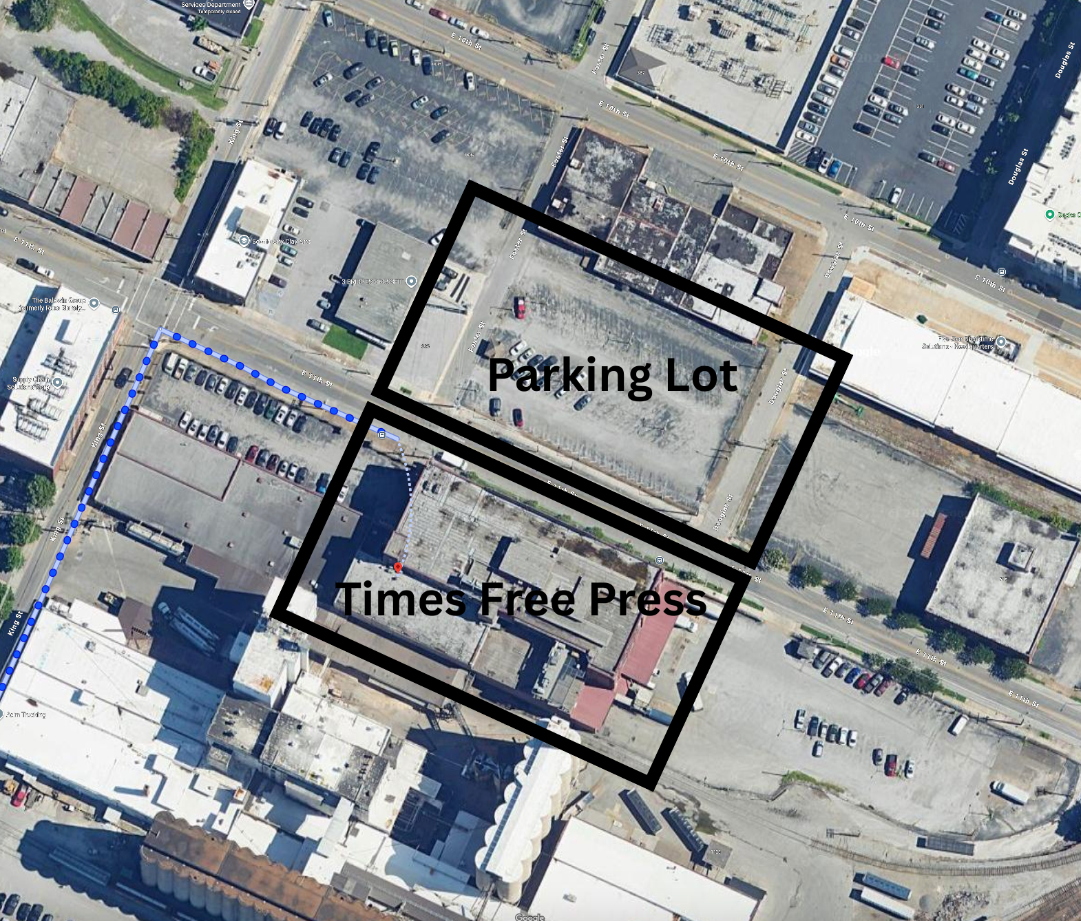 Aerial view of a city block with a parking lot and the Times Free Press building outlined in black.