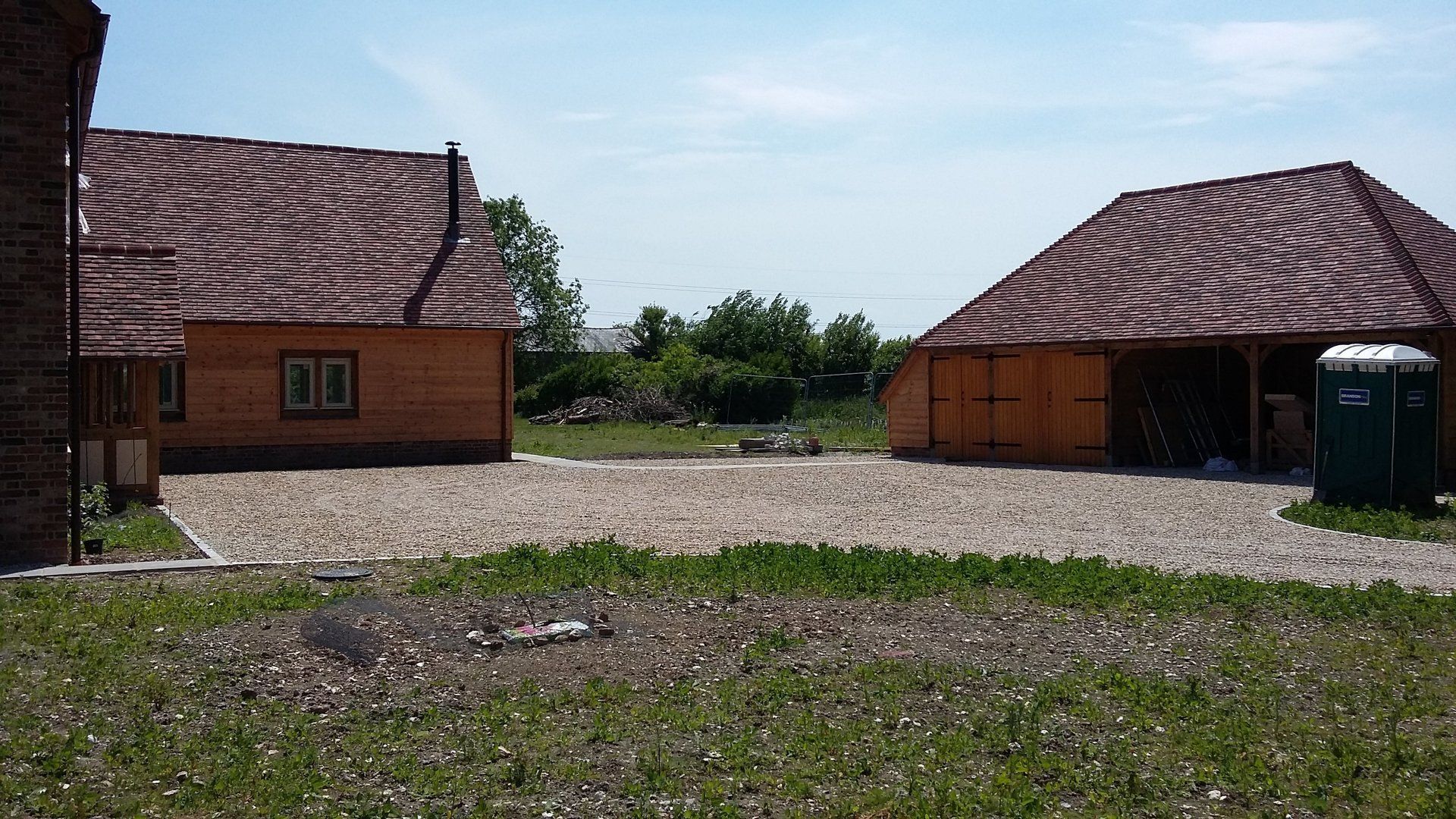 Two houses are sitting next to each other in a grassy area.