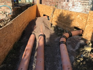 Davis Groundworks | A bunch of pipes are laying in a pile of dirt.