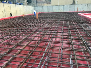 A close up of a concrete floor with a metal mesh.