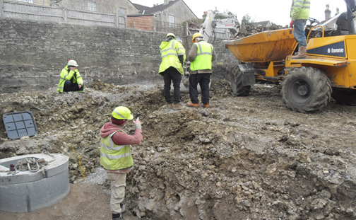 A group of construction workers are working on a construction site.
