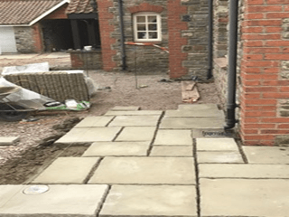 A walkway is being built in front of a brick building