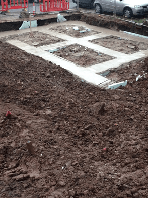 A construction site with a lot of dirt and concrete.