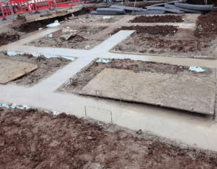 A construction site with a lot of dirt and concrete