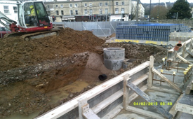 A construction site with a bulldozer and a pile of dirt