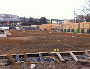 A construction site with a wooden fence surrounding it