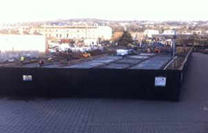 A construction site with a black fence around it