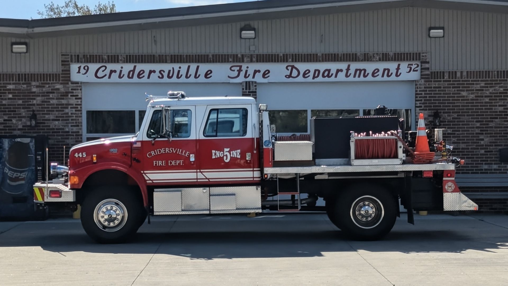 Red and white fire truck in front of the