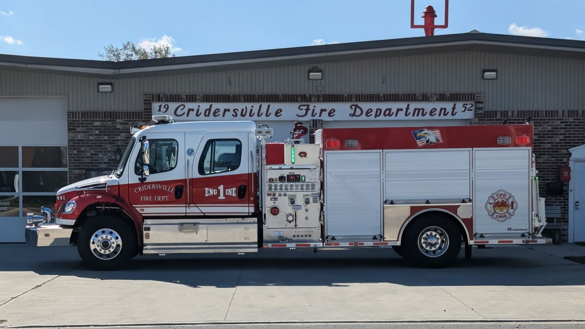 Fire truck parked in front of a building with the words