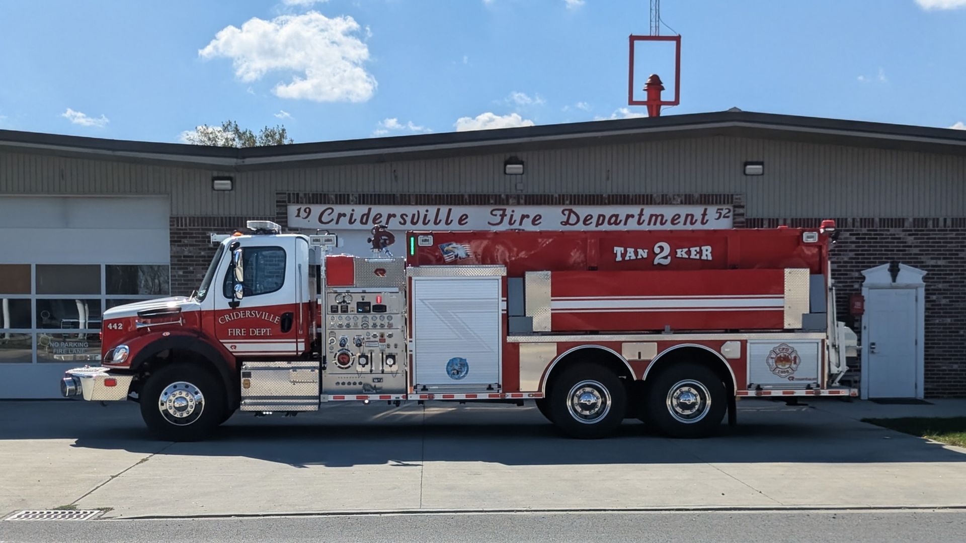 Red and silver fire truck parked in front of the Cridersville Fire Department building.