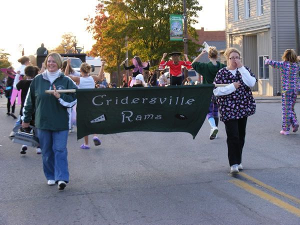 People in a parade carry a banner that says 