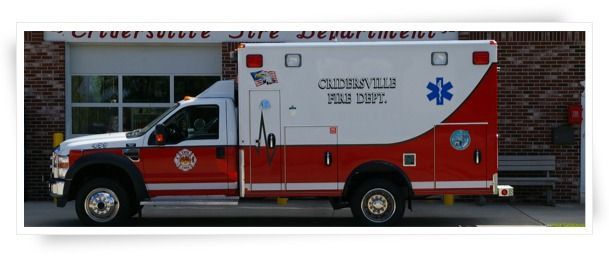 Ambulance for Crisfield Fire Dept. in front of a brick building.