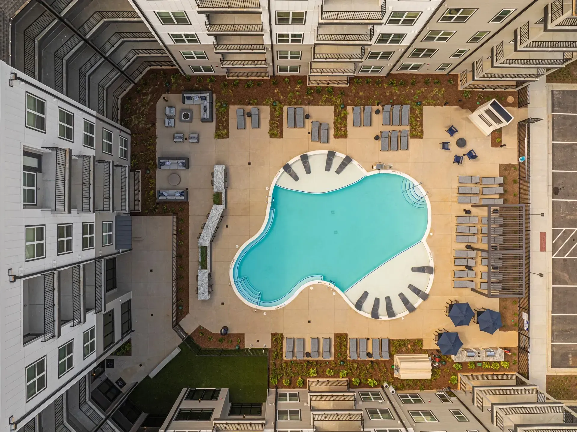 An aerial view of a large swimming pool surrounded by buildings