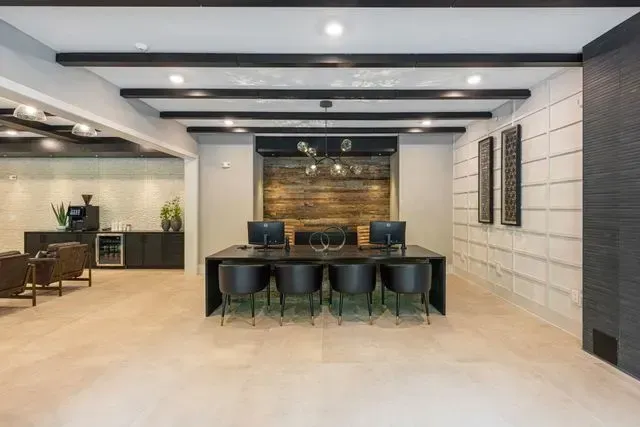 A large room with a table and chairs in it